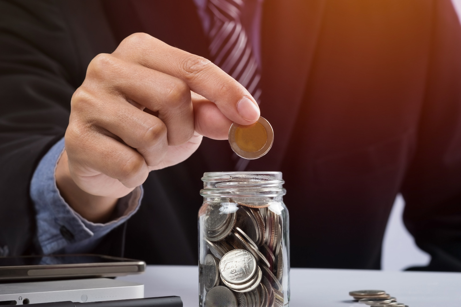 hand-putting-mix-coins-seed-clear-bottle-copyspace-business-investment-growth-concept